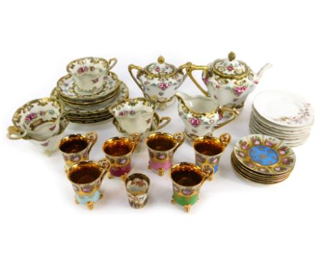 A Continental porcelain part tea service, decorated with pink roses, gilt heightened, to include two handled lidded sugar bow