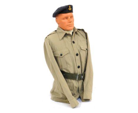 A half male mannequin, wearing RAF tropical shirt and blue beret.