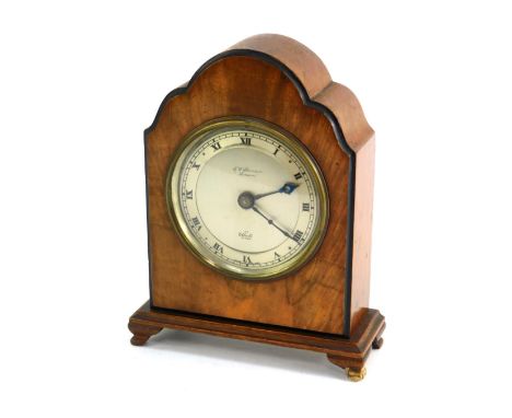 An early 20thC oak and walnut cased Elliott mantel clock, the silvered Roman numeric circular dial bearing name for J W Benso