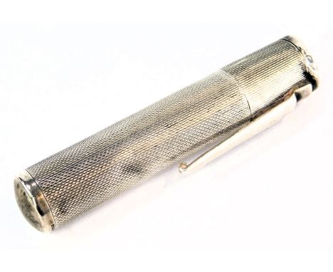 A Colibri cigarette lighter, of engine turned decoration formed as a pen case, white metal stamped sterling silver, 0.71oz. 