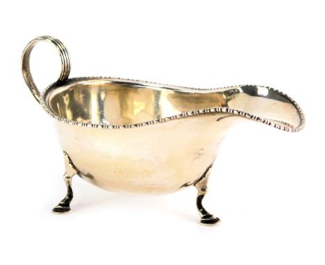A George V silver sauce boat, with beaded border, on tripod capped feet, Birmingham 1928, 3.67oz. 