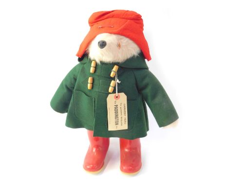 A Gabrielle Designs 1970s Paddington Bear, with green felt duffel coat and red Dunlop wellingtons, 47cm high. 