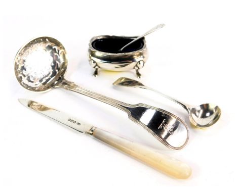 A group of silver wares, comprising a silver bladed and mother of pearl handled butter knife, a silver toddy ladle, silver cr