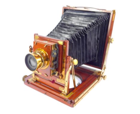 An early 20thC Thornton Pickard half plate camera, the mahogany case numbered 10382, with time and instantaneous lens and bra