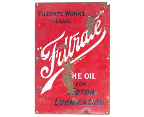 An enamel sign for Filtrate Works Leeds, The Oil for Motor Lubrication, single sided, black and white lettering against a red