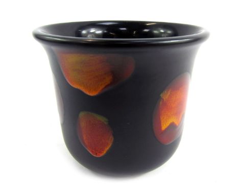A Poole pottery planter, on a blackened ground with orange disc decoration, stamped to underside, 13cm high.