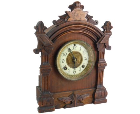 A late 19thC American Ansonia shelf clock, with eight day movement and Arabic numerals to the chapter ring, in an architectur