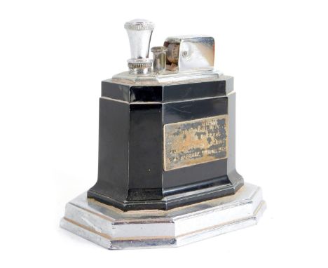 A Ronsons touch tip tabletop lighter, on a blackened ground with steel mouldings, bearing presentation crest to Pilot Office 