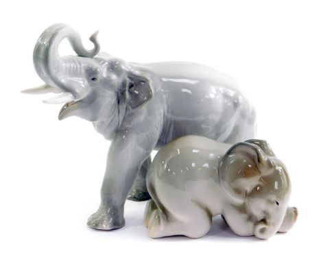 Two Russian Lomonosov porcelain elephants, one in standing pose with trunk raised, 20.5cm high, and the other of a baby eleph