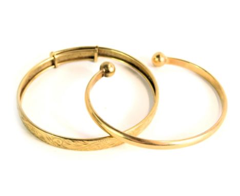 A 9ct gold torc bangle, 16.1g, and an unmarked yellow metal bangle, with sliding scale, 7.9g. (2) 