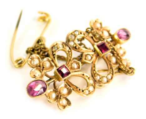 A ruby, garnet and seed pearl bar brooch, formed as two bows on single pin back with safety chain, yellow metal unmarked, 2.5