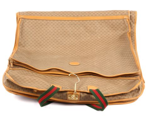 GUCCI a coated canvas and leather vintage zipped Sherry Line suit carrier with GUCCI combination lock.(Code 009) Gold coloure