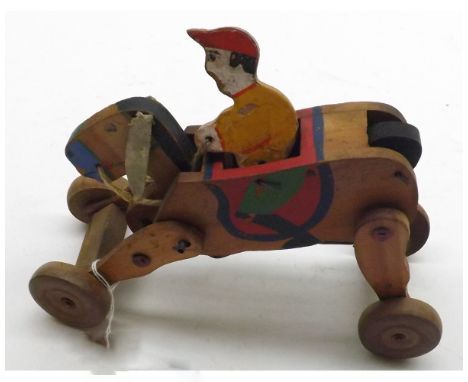 A vintage wind-up Childs Wooden Wheeled Horse and Jockey, decorated in colours, 6  long