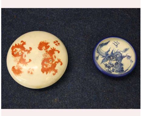 A Chinese Circular Covered Container of compressed form, painted in iron red with temple dogs and the base with inscription t