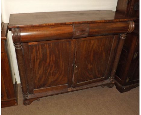 A 19th Century Mahogany Sideboard with two cushioned frieze drawers over pillared side supports and two doors, raised on shor