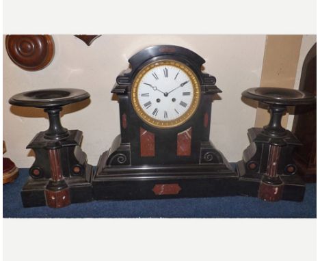 Late 19th Century French black and variegated rouge marble Clock Garniture, the arched case with overhanging cornice, scrolli