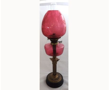 Large late 19th Century oil lamp with cranberry glass shade with frosted floral detail, cranberry glass font, raised on a Bra