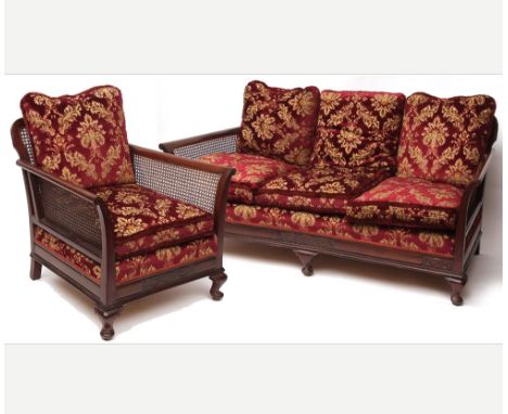 Early 20th Century Mahogany framed Bergere three-piece suite, comprising three seater sofa and pair of armchairs, all with fl