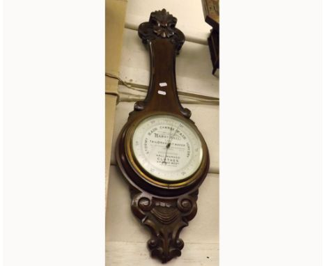 Early 20th Century Walnut cased Aneroid Barometer, the case with carved seascroll and foliate detail (lacking Thermometer) to