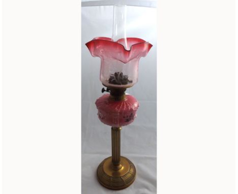 Late 19th Century Oil Lamp, clear glass chimney, cranberry tinted shade, opaque glass font, raised on a brass pedestal and sp