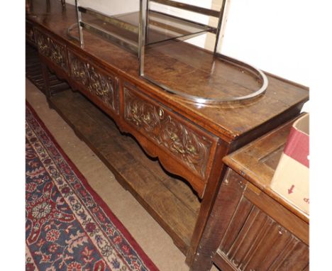 An 18th Century and later Oak Dresser Base, the plain top over three later carved frieze drawers, on plain supports with a so