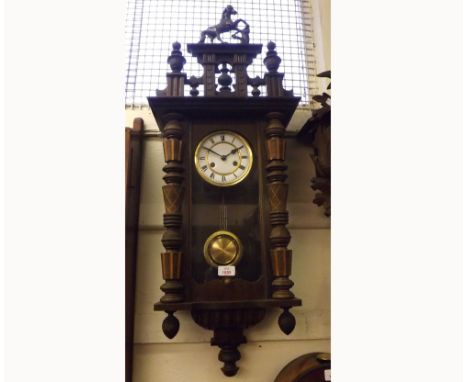 20th Century Walnut cased Vienna type Wall Clock, the overhanging cornice surmounted by a pierced pediment with finials and r