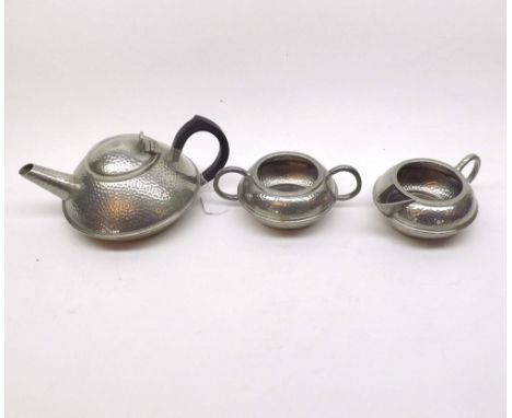Early 20th Century British hammered Pewter Tea Service, of squat form, comprising Tea Pot, Sugar Basin, and Milk Jug, largest