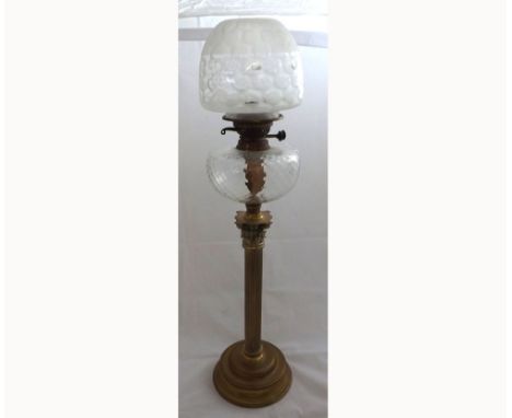 Large late 19th Century Oil Lamp with frosted glass shade, clear glass font raised on a ribbed Brass pedestal and spreading c