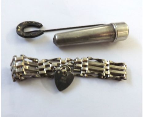 A Mixed Group comprising: a hallmarked Silver Four Bar Gate Bracelet with padlock; a hallmarked Silver Stick Pin with horsesh