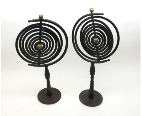 Pair of vintage Cast Iron Planetary Orbit Stands formed as concentric circles, raised on pedestal bases and spreading circula