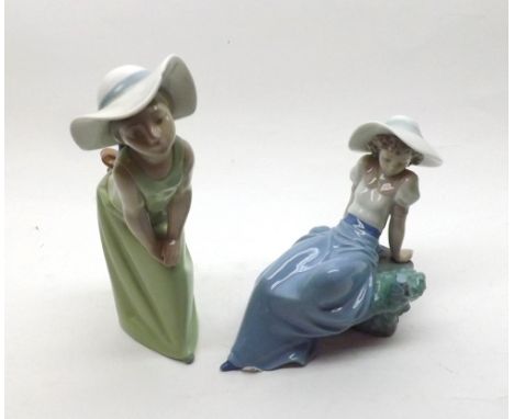 Lladro figure of a young girl bending forward wearing a wide brimmed hat a pale green dress, further Nao model of a young gir