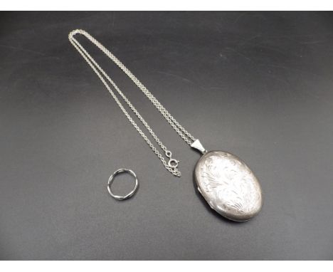 A silver hallmarked locket on a chain (Birmingham 1978) and a silver ring size M, total lot weight 25.37g