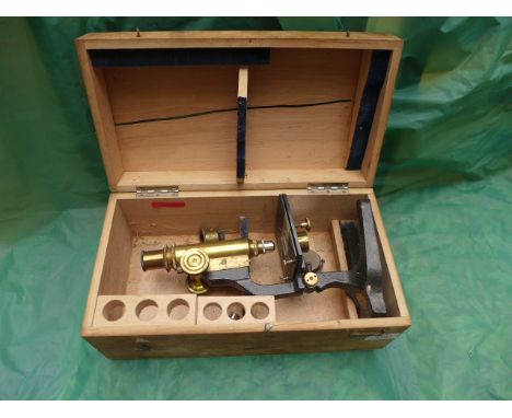 Brass microscope in storage box