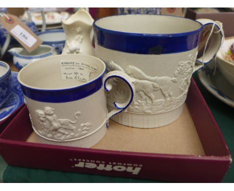 2 19th Century stoneware tankards embossed with scenes of hunting and revelry, each with blue rim and (acanthus leaf) handles