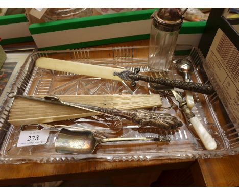 Glass dressing table tray containing mother of pearl handled bread fork, sifter spoon, bone letter knife, ladies fan, button 