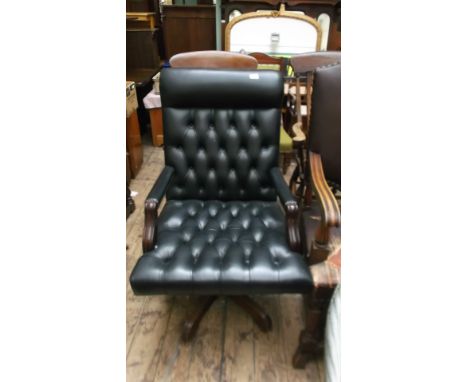 High button backed back and seated swivel office armchair, the studded arms back and seat upholstered in black leather