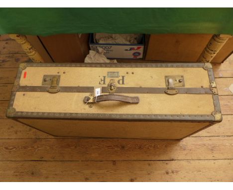 Large metal bound beige canvas travelling trunk with brass locks
