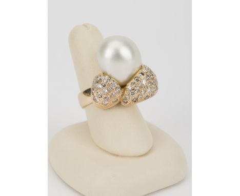 DESCRIPTION: 14k ring set with approximately 19mm baroque style pearl. Forty-eight pave set diamonds in bow motif, approximat