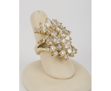 DESCRIPTION: 14k ring set with thirty-three round brilliant cut diamonds in waterfall style cluster. Approximately 7.6 CTW (C