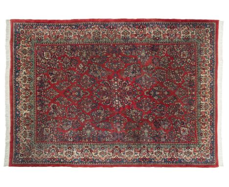 DESCRIPTION: Persian Sarouk room size rug. Iran, 1940's. Red ground with blue and cream floral design and border. Labeled. ME