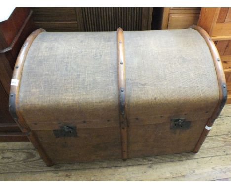 A vintage domed top canvas covered travelling trunk