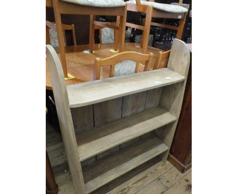 A shaped light pine three shelf floor standing bookcase
