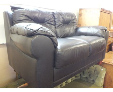 A modern dark brown two seat leather sofa