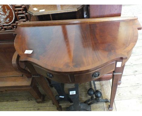 An oak standard lamp with revolving shelf and reproduction two drawer hall table