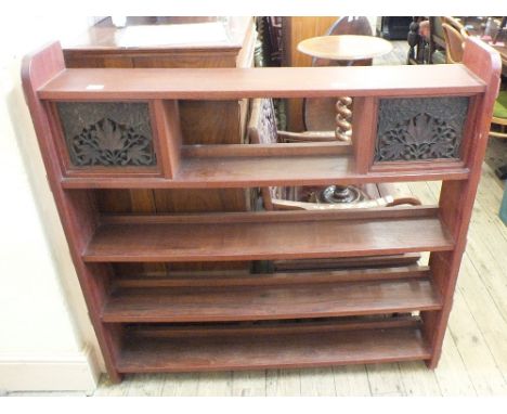 A mahogany five shelf bookcase with two reclaimed carved panels