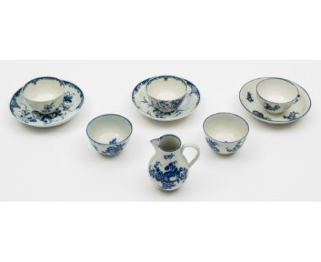A group of Worcester First Period porcelain: comprising three tea bowls, a saucer and cream jug printed in blue in Fruit Spri