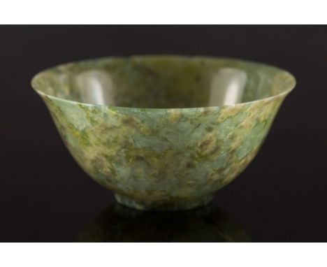 A Chinese spinach green jade bowl: with flared rim and short foot rim, the stone of mottled green, grey and cream colour, 10 