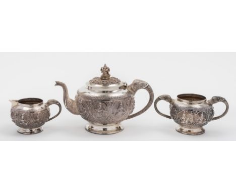 An Indian silver three-piece tea service: of circular outline, having banded decoration of circular panels containing dancing