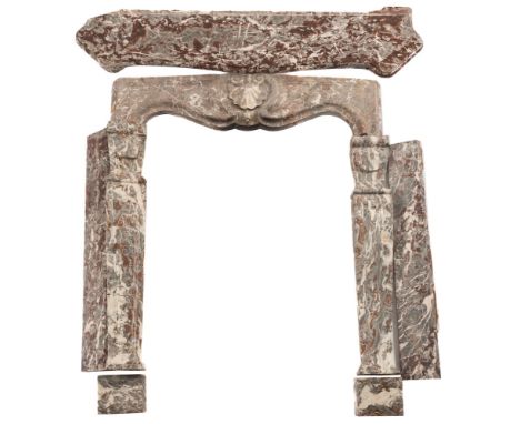 A grey and white variegated marble fire surround: with shell decorated frieze between curved stiles,on plinth bases, 145cm. w