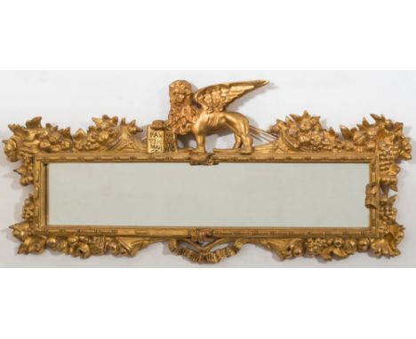 A 19th century carved giltwood rectangular landscape wall mirror: of small size, surmounted by a figure of a winged lion with